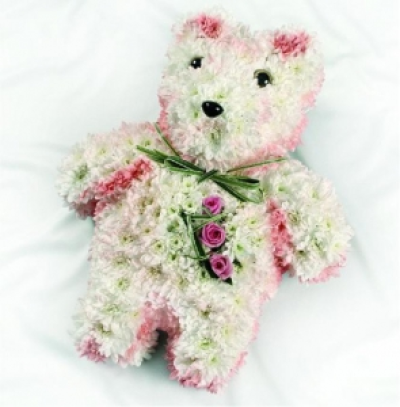 pink teddy - Double spray chrysanthemums, spray carnations are used to create this pink and white bespoke design shaped like a teddy bear.