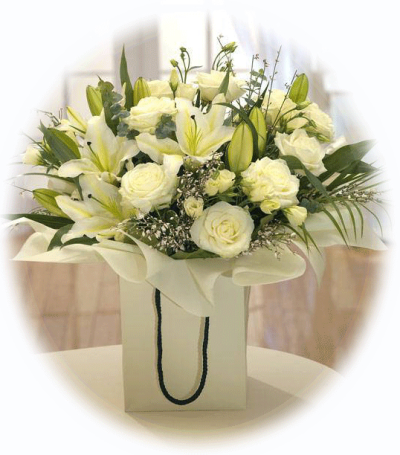 Luxury White Hand-tied - Selection of Fragrant white oriental lilies and white roses combine beautifully to make this stylish hand-tied bouquet. Beautifully presented in a gift box ready to enjoy.